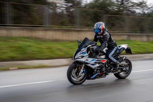 Free High-speed motorcyclist riding a modern sports bike on a highway in motion blur. Stock Photo