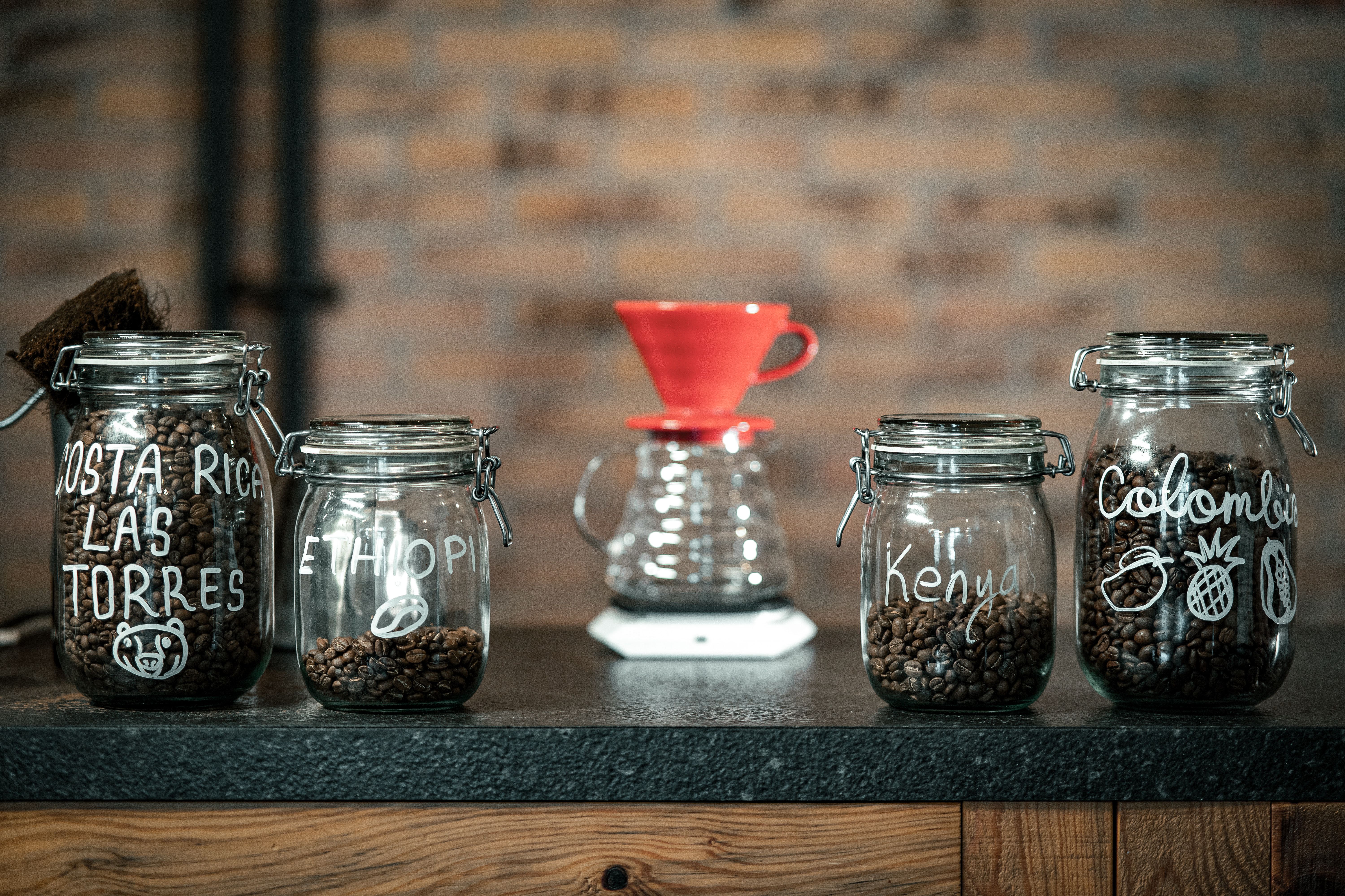 Artisan coffee jars from various origins in a boutique cafe setting in Bursa, Türkiye.
