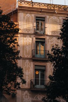 Elegant facade of a historic European building with decorative plasterwork. Captured in warm light.