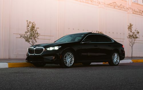 Free A stylish black sedan car parked on a city street in Erbil, Iraq during the day. Stock Photo