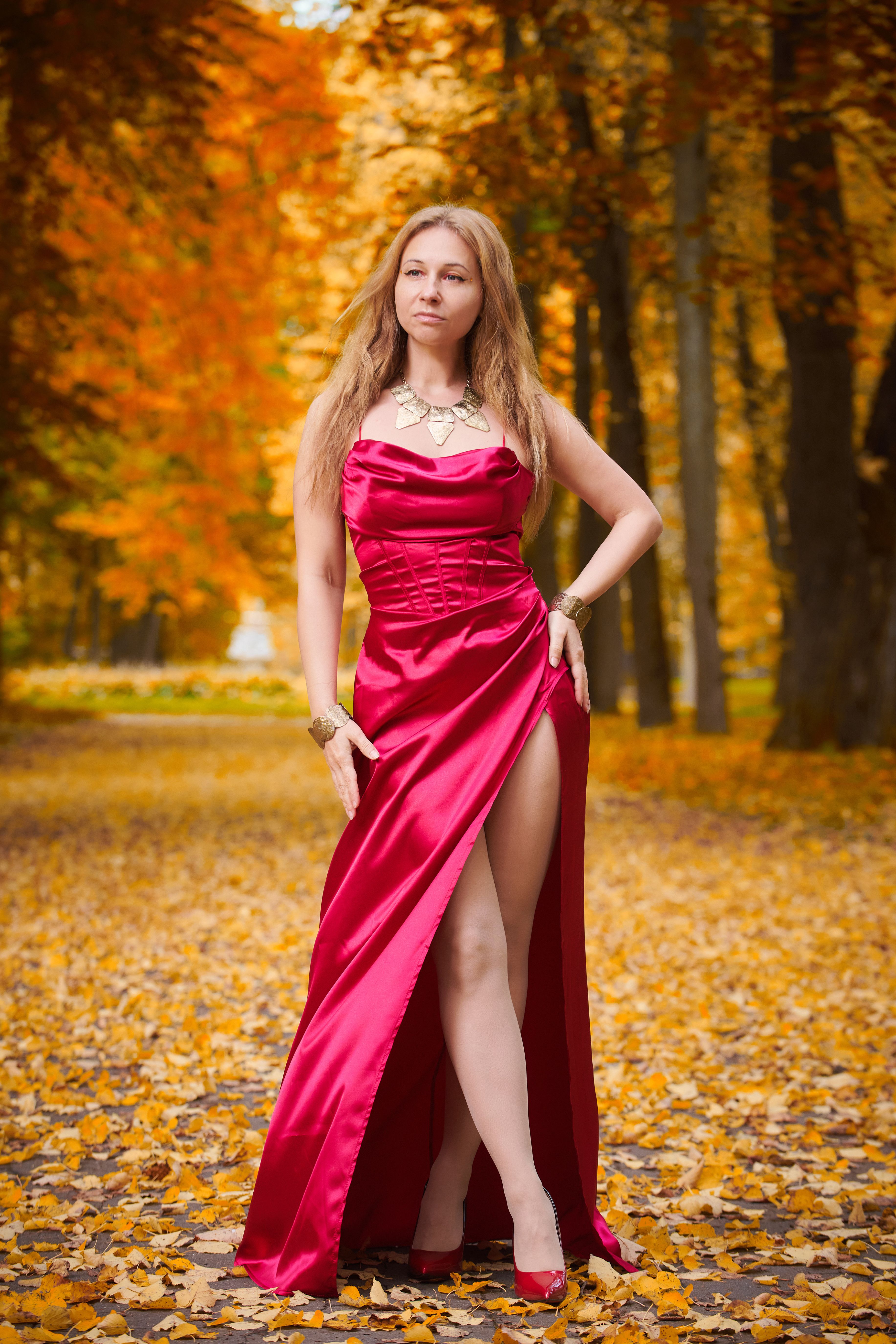Elegant Woman in Red Dress amidst Autumn Leaves · Free Stock Photo