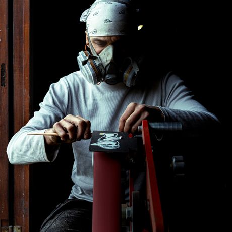 Artisan shaping a piece at a lit workbench — Alex Grandidier on Pexels
