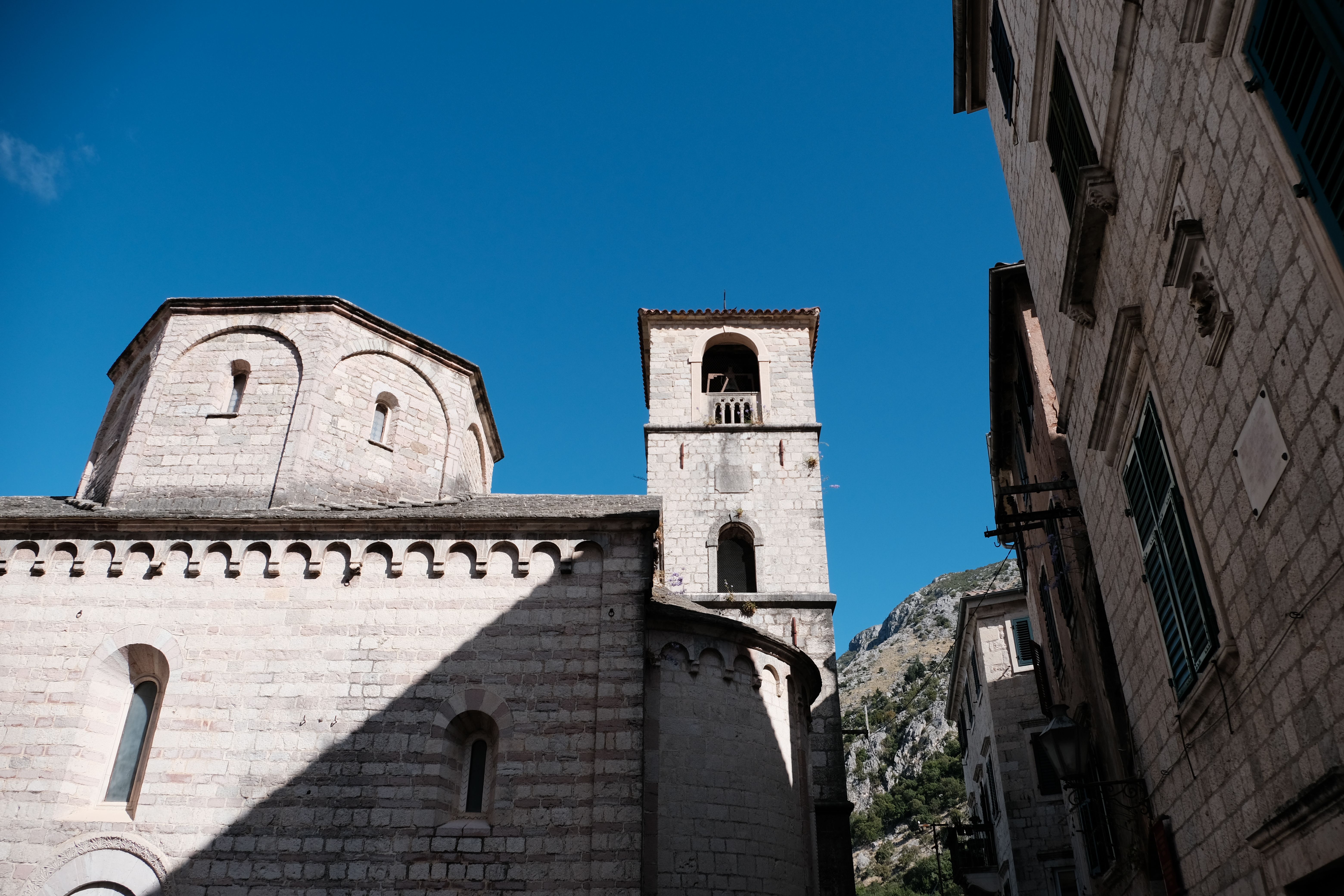 Historic Stone Buildings Against Blue Sky · Free Stock Photo