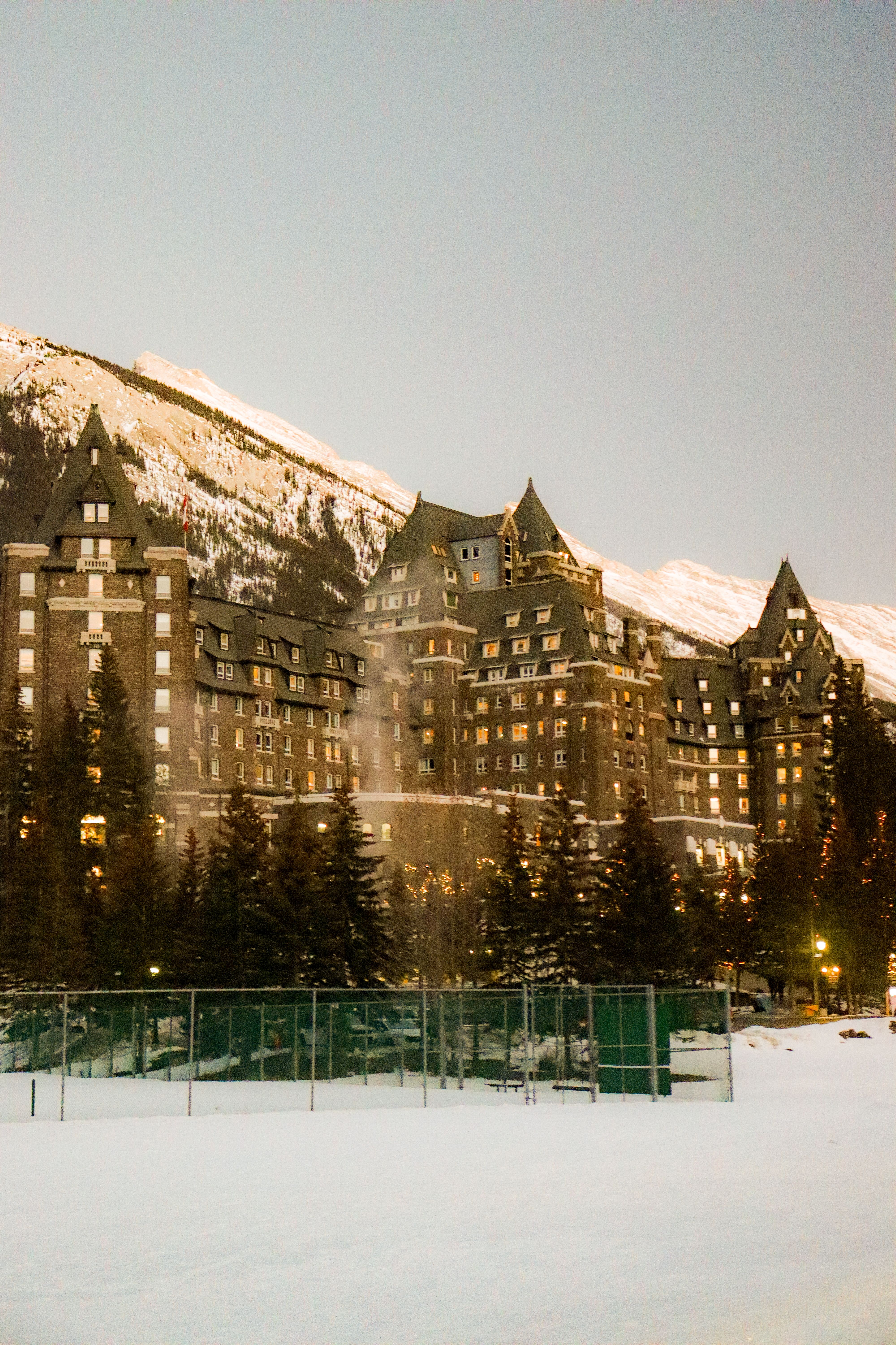 Grand hotel surrounded by snowy mountains in winter