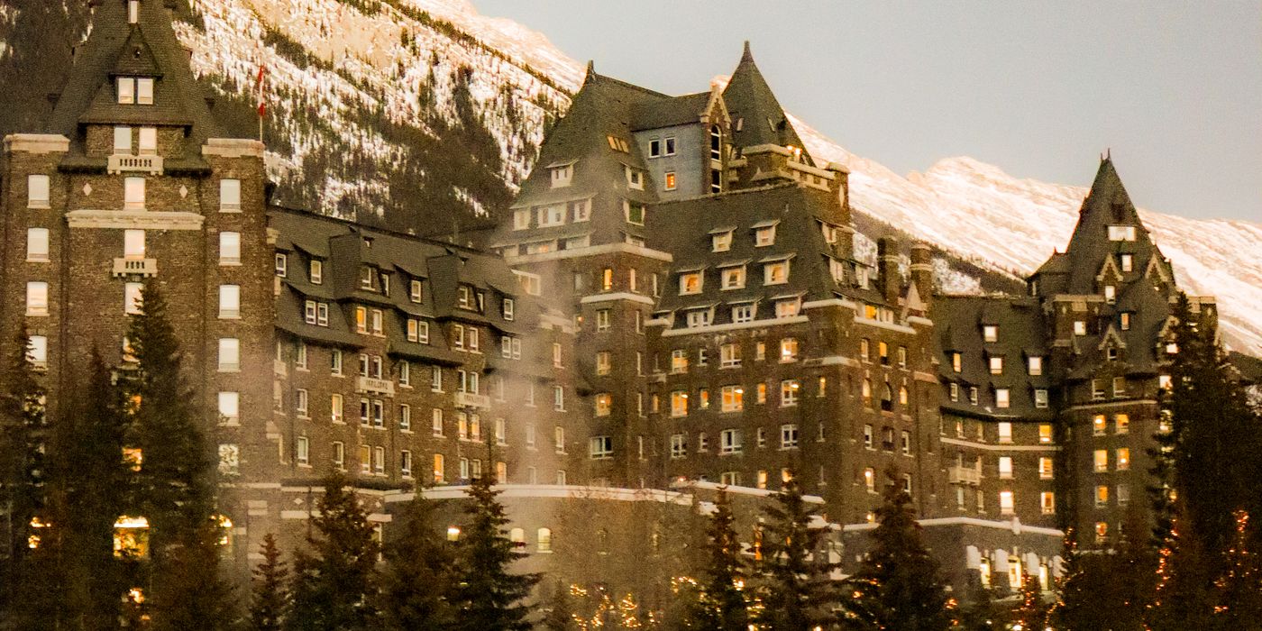 Grand hotel surrounded by snowy mountains in winter