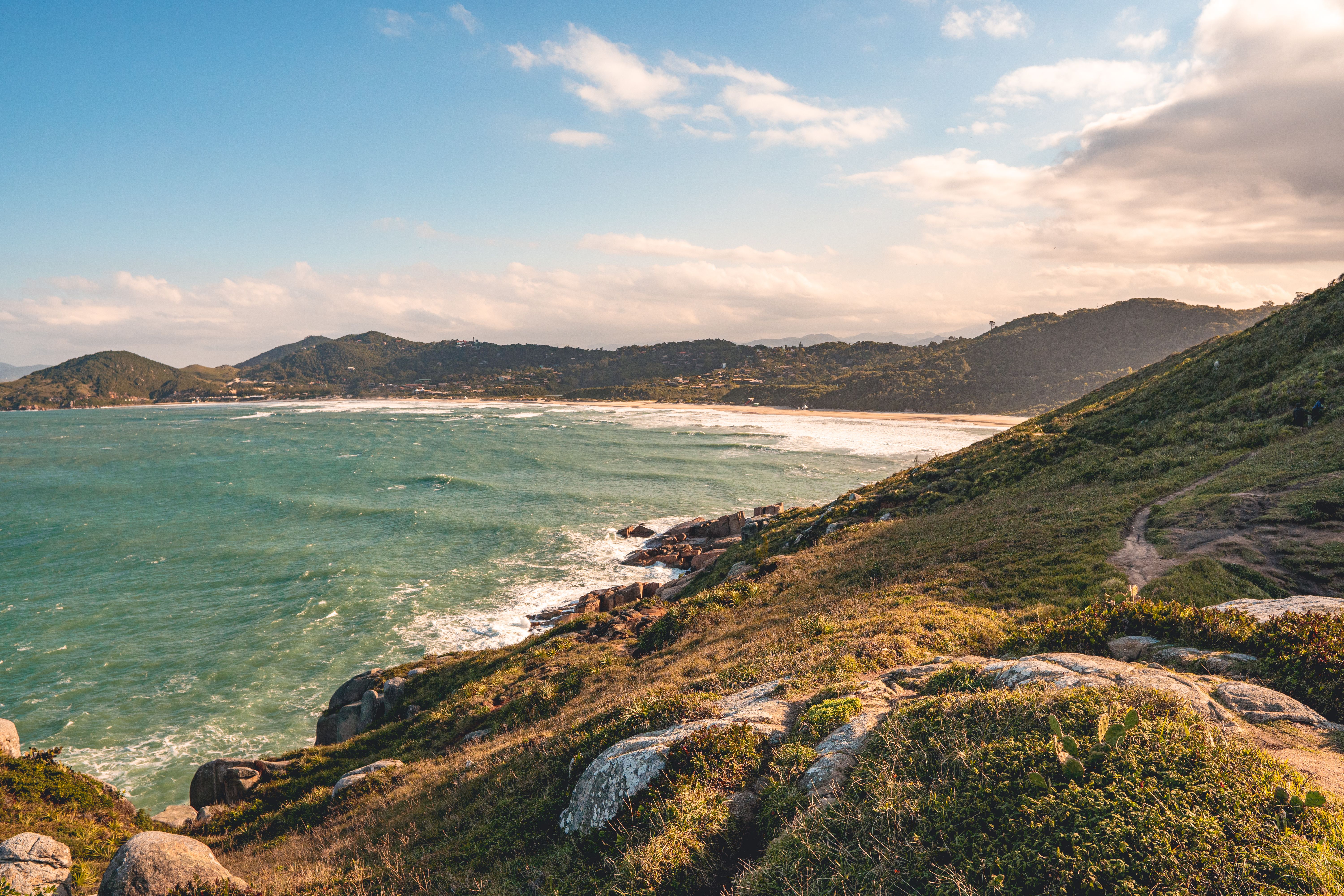 Serene Coastal View with Green Hills and Blue Ocean · Free Stock Photo