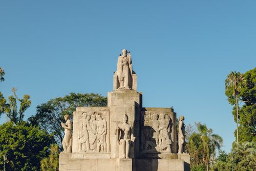 Free Statue and reliefs in a Buenos Aires park against a clear blue sky. Stock Photo