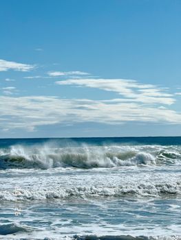 Peaceful ocean waves on a sunny day, perfect for a relaxing coastal escape.