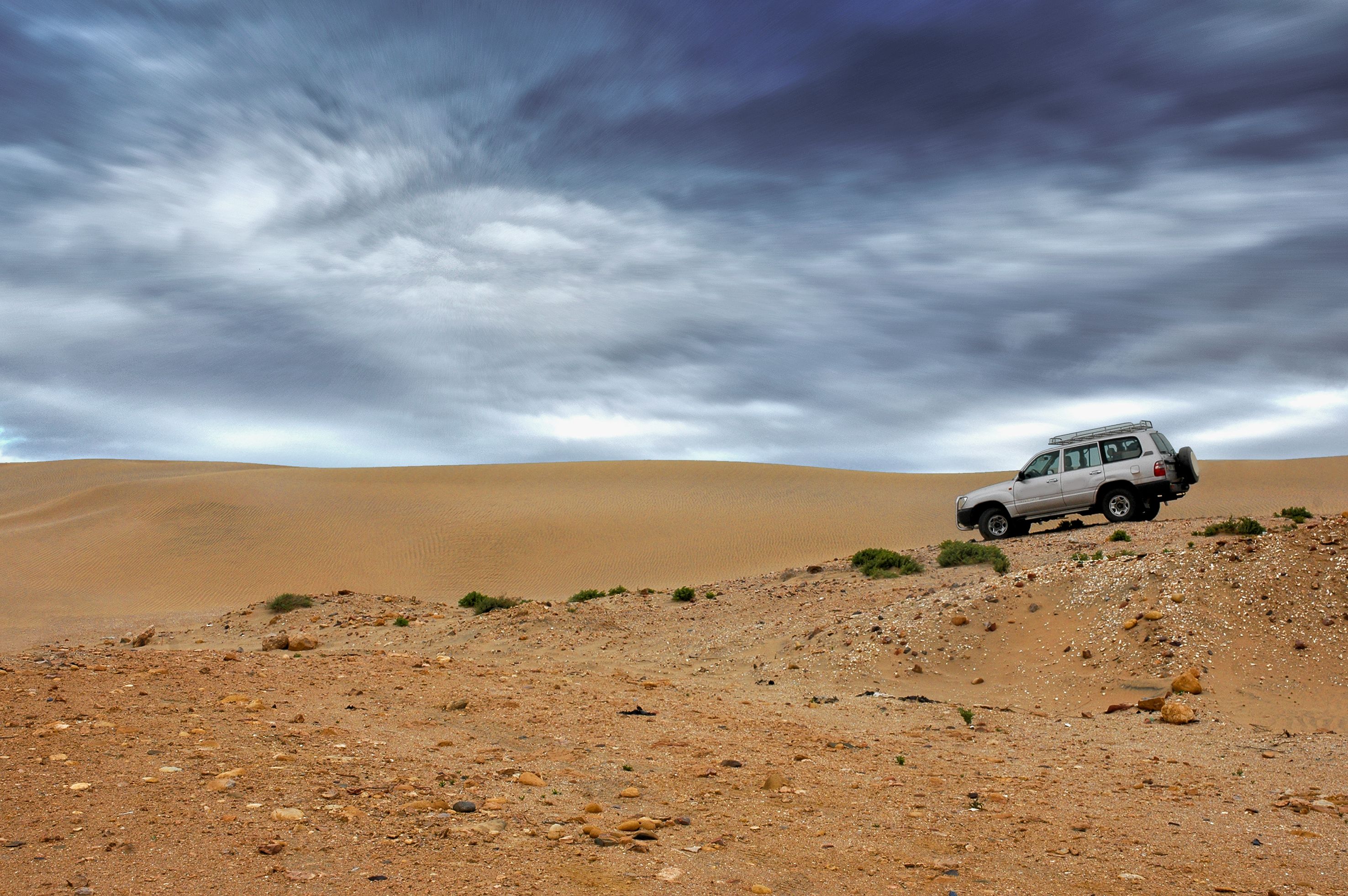 Amazing Shark Cage Diving Tour from Cape Town Review: Face Your Fears with Great Whites Review 2026 - A solitary off-road vehicle in the vast Tan-Tan desert, showcasing adventure and exploration in Morocco's stunning landscape.