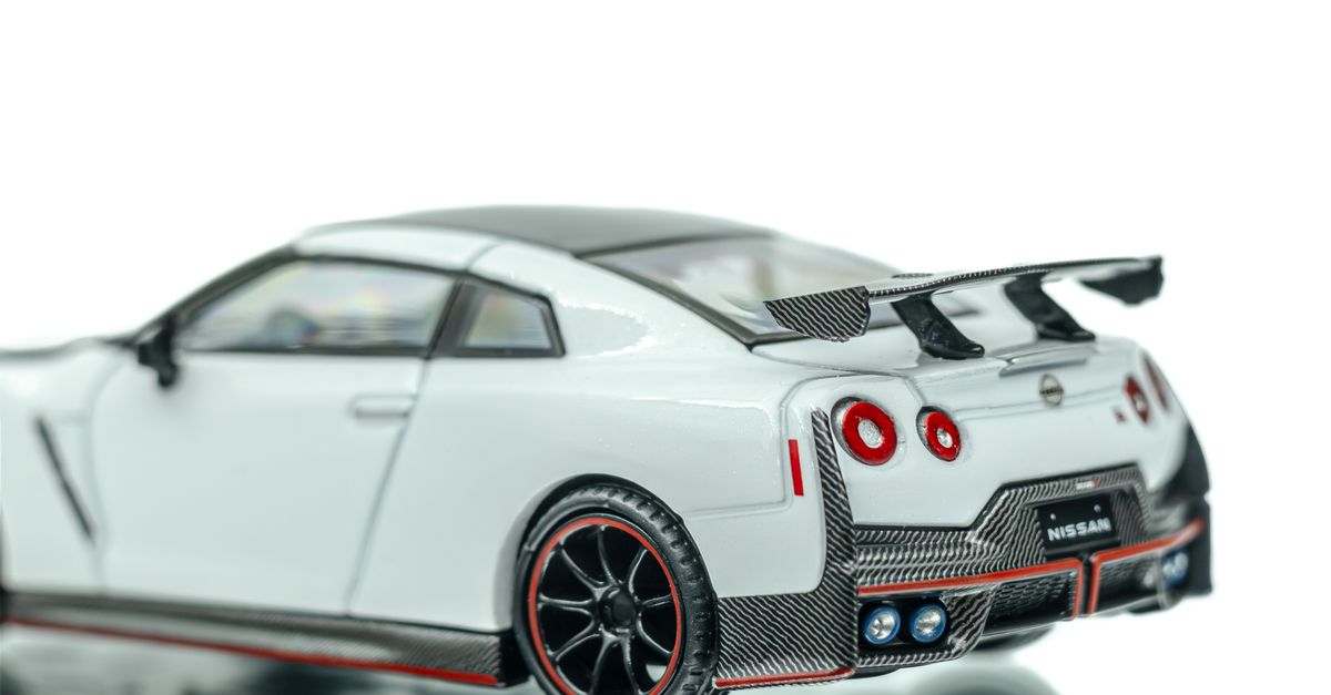 Sedan Model Cars Rear Model Car on Reflective Surface Captured Close Up ยท Free Stock Photo