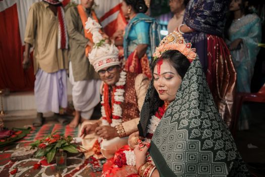 A vibrant Indian wedding ceremony with bride and groom adorned in traditional attire.