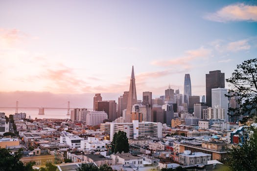 Stunning view of San Francisco cityscape with iconic landmarks during sunrise. by KEHN HERMANO