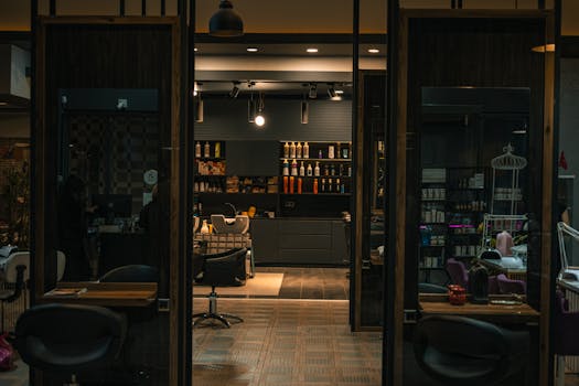 Cozy and stylish hair salon with modern decor and warm lighting, captured at night.
