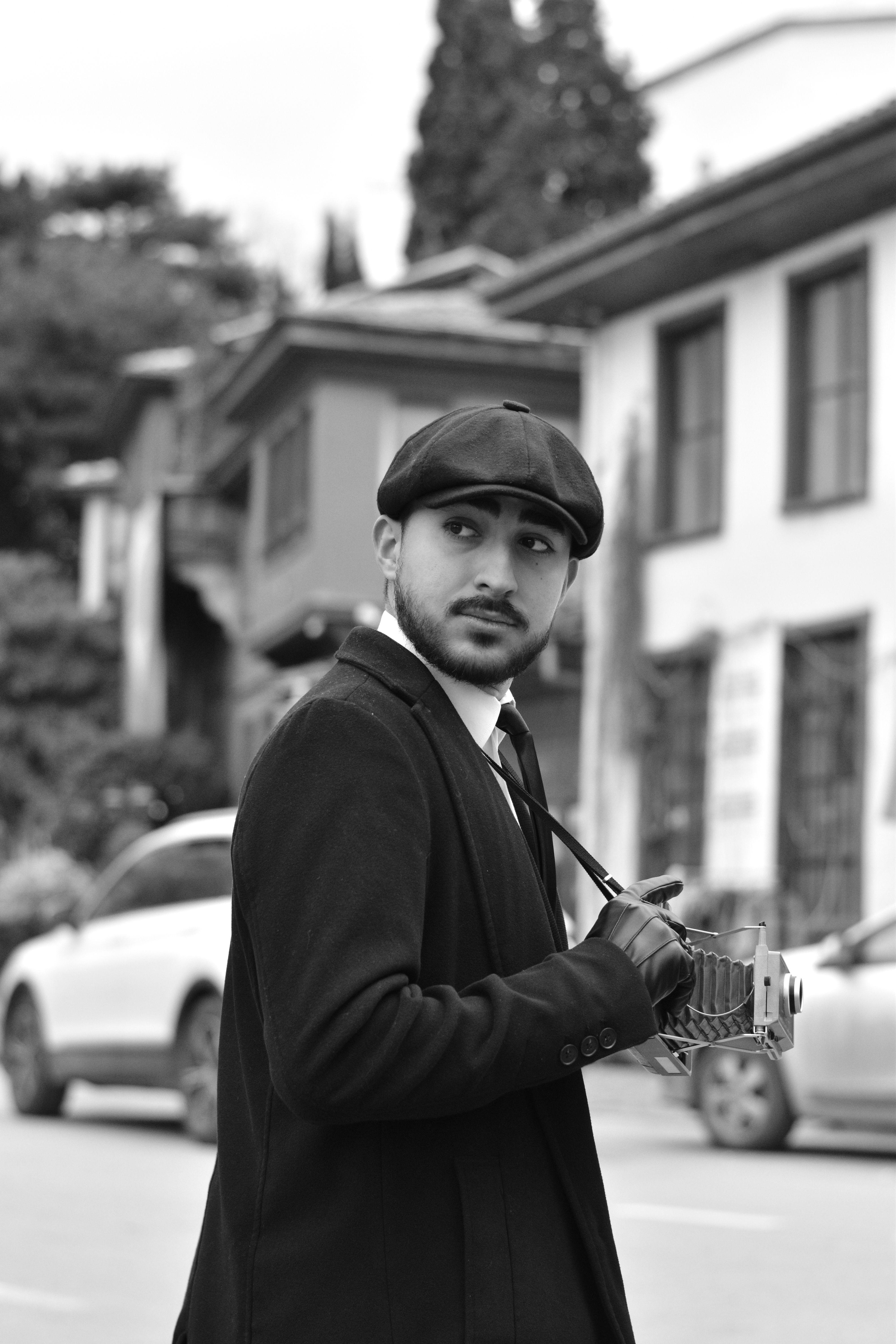 Retro black and white portrait of a man with camera in Bursa, Türkiye.