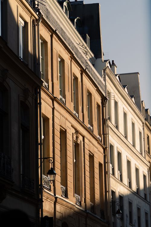 Free Stunning Parisian buildings highlighted by the warm glow of golden hour sunlight. Stock Photo