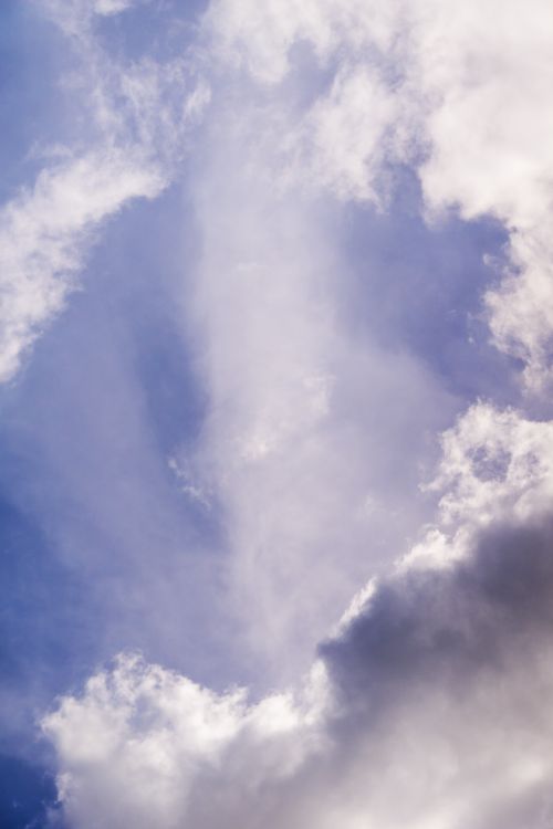 Free A captivating view of dramatic clouds against a vibrant blue sky, creating a striking natural scene. Stock Photo