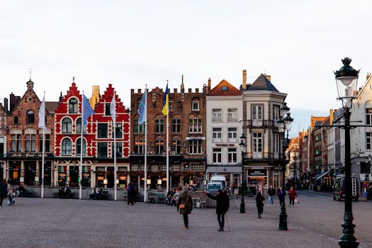 Colorful historic buildings in Bruges' Markt Square, a UNESCO World Heritage site.