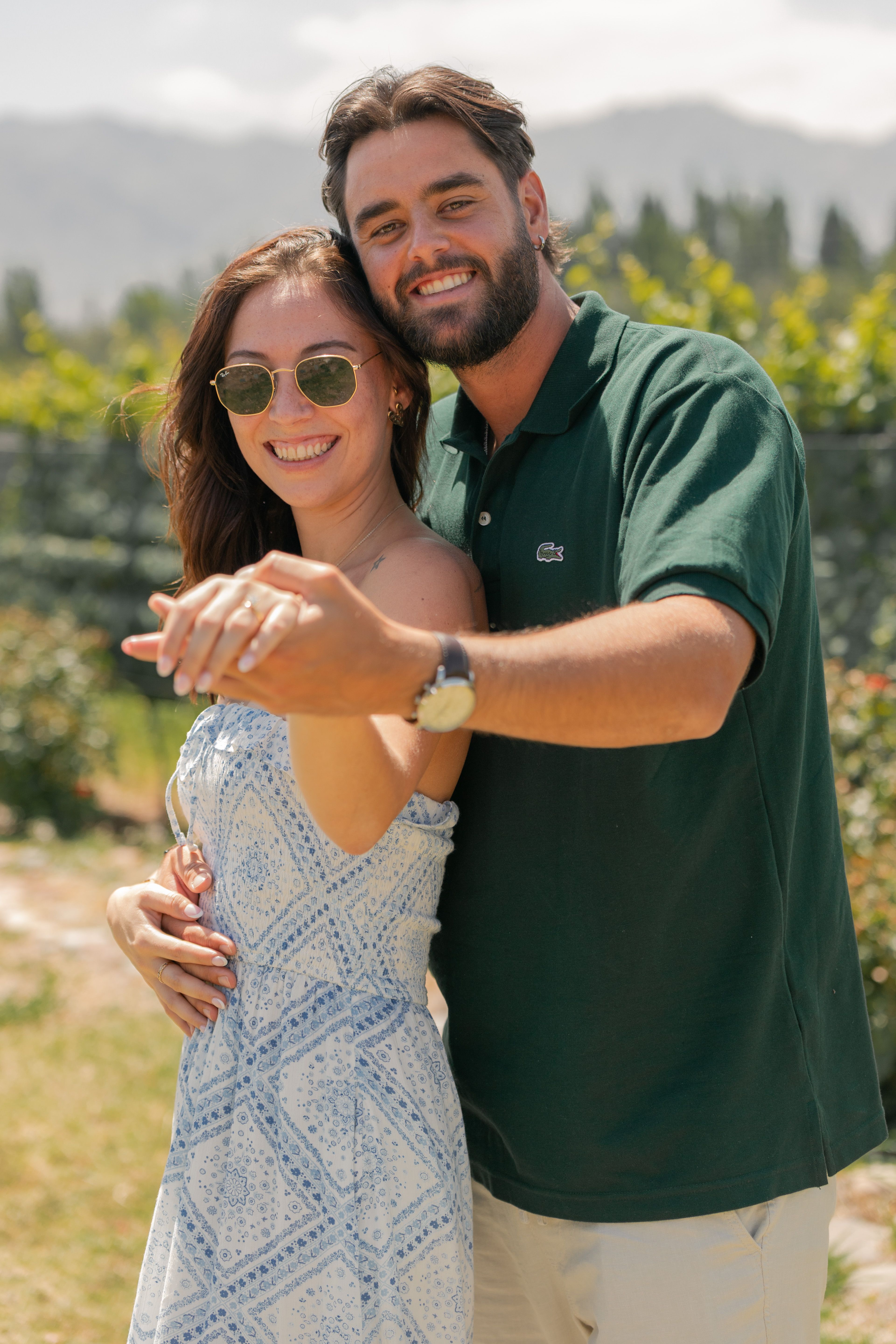 Engaged couple celebrating in a beautiful vineyard setting in Mendoza, Argentina.