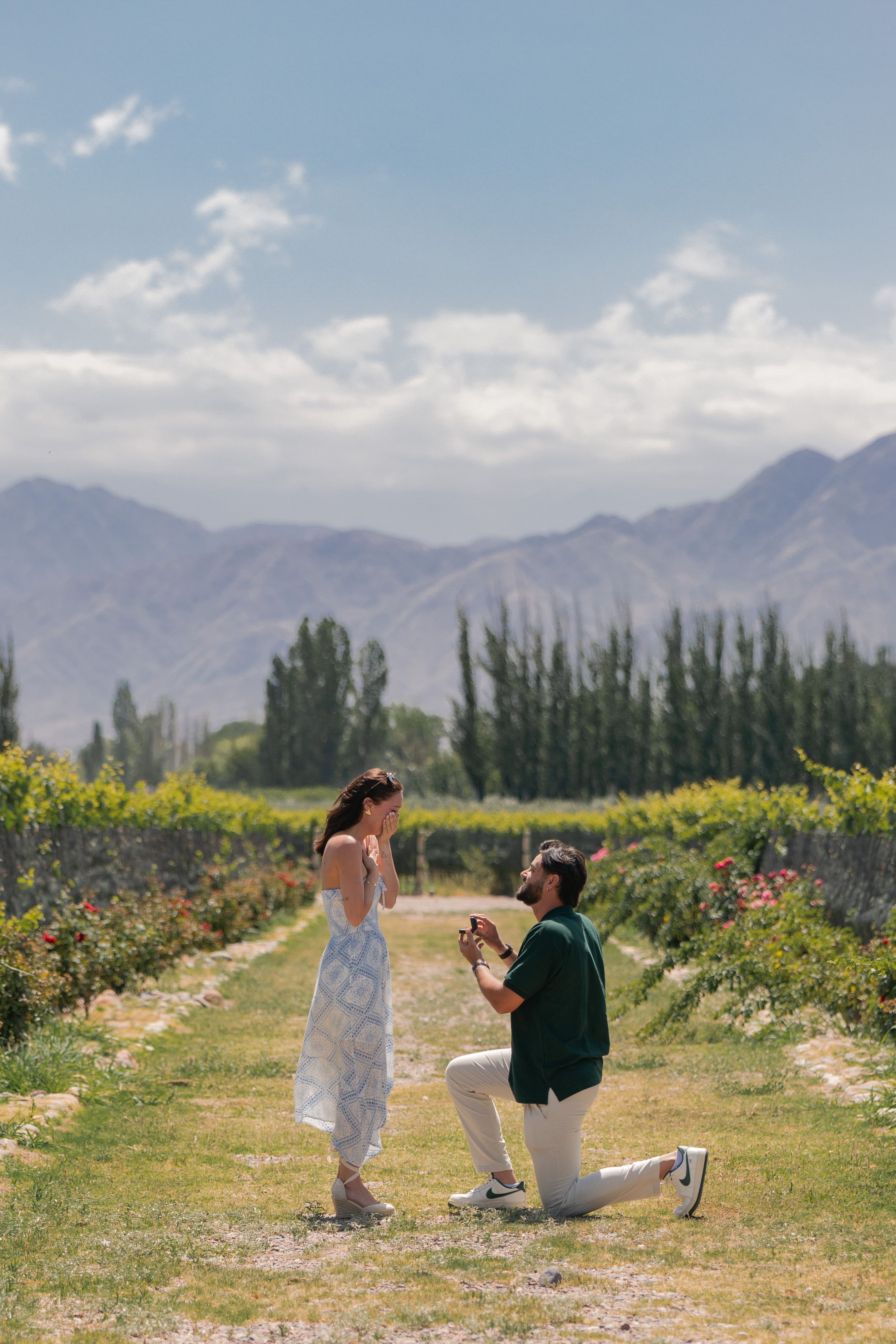 A man proposes in a picturesque vineyard in Mendoza, Argentina with mountains as backdrop.