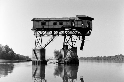Free Black and white photograph of a historic industrial structure over the Danube River in Esztergom, Hungary. Stock Photo
