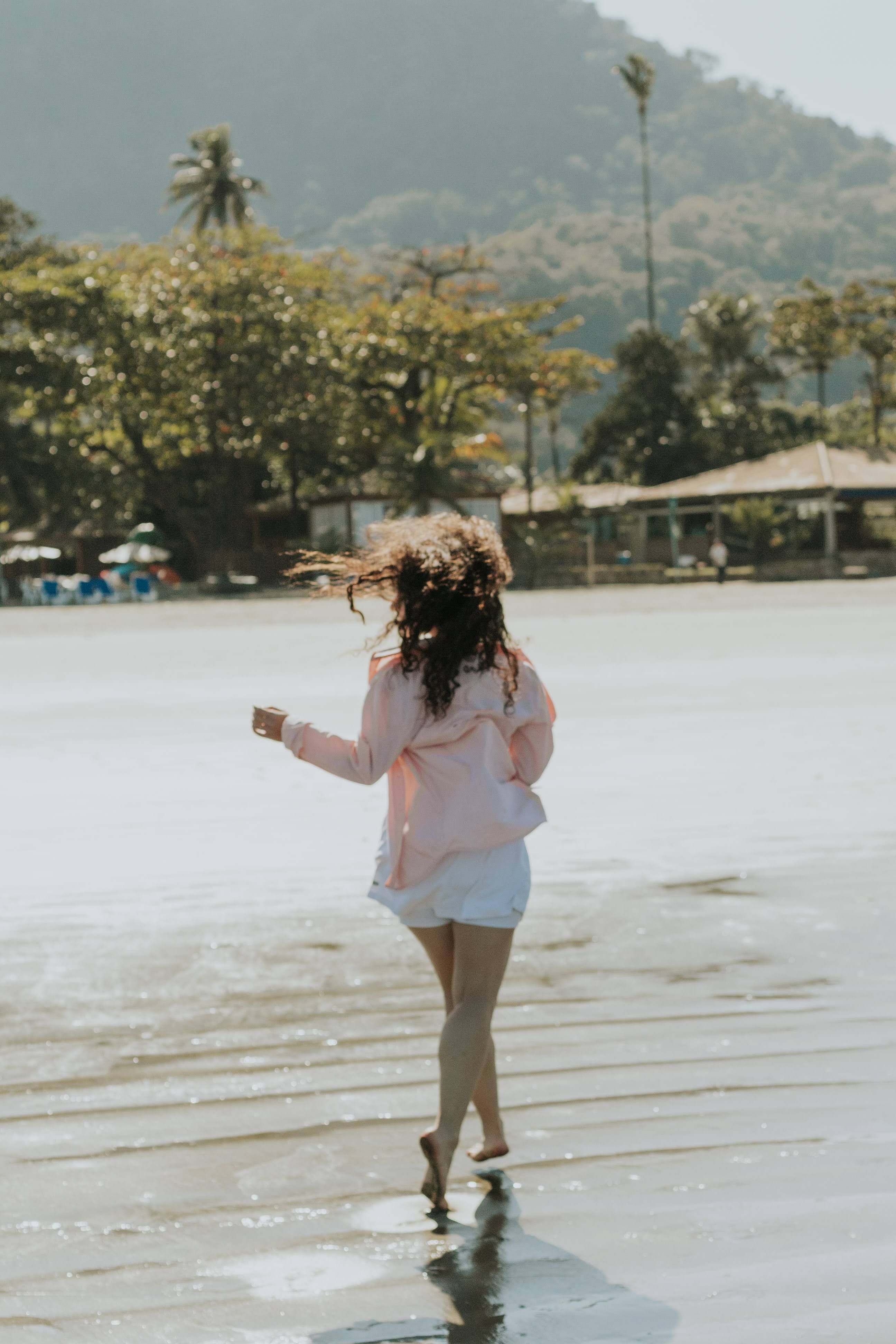 Woman Enjoying a Sunny Day at the Beach · Free Stock Photo