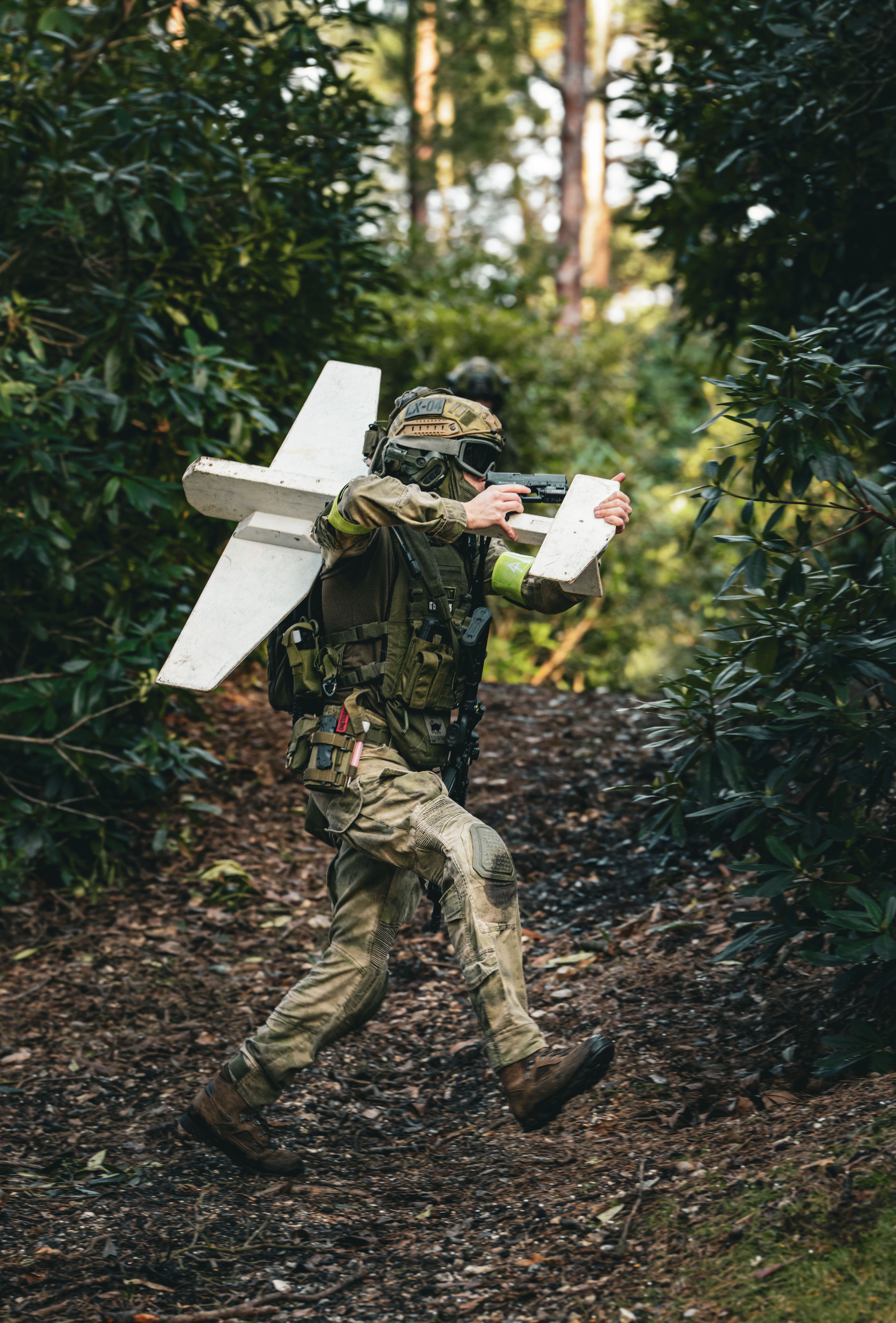 Military Soldier Navigating Forest with Drone Equipment · Free Stock Photo