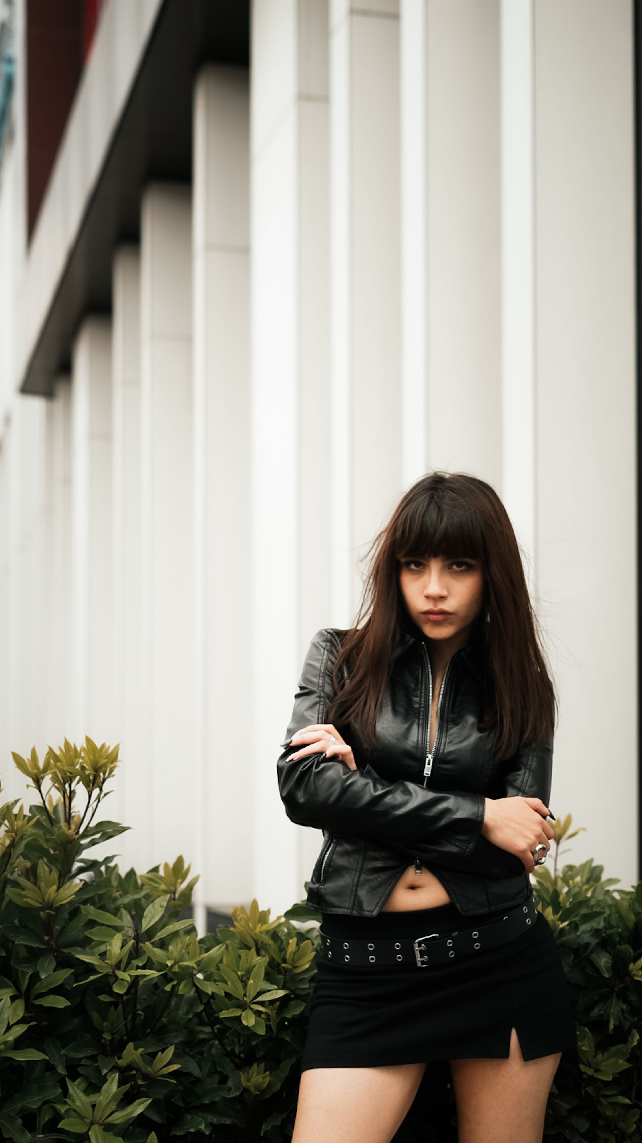 Woman in leather jacket with satin skirt
