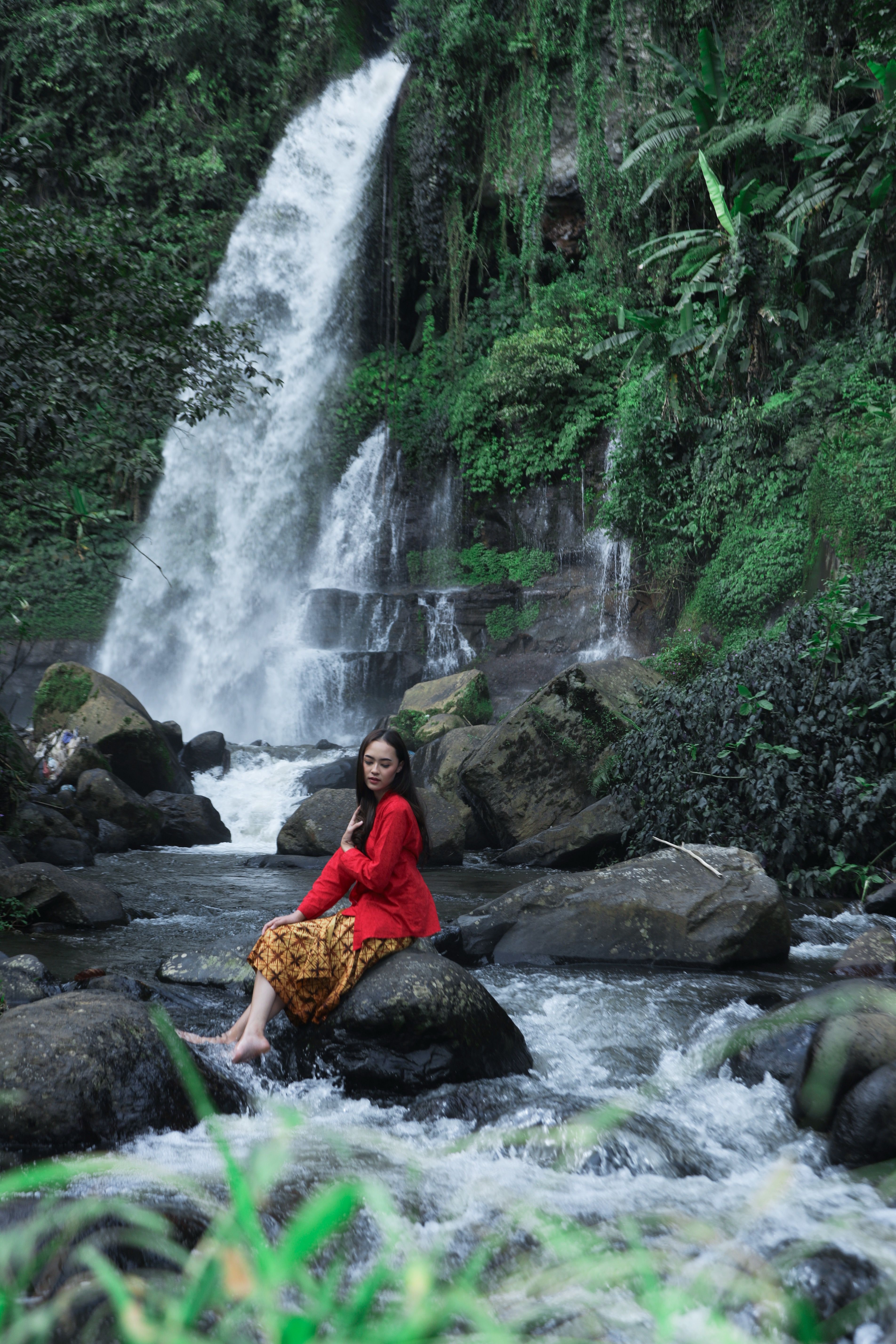 Woman Posing by Lush Waterfall in Tropical Jungle · Free Stock Photo