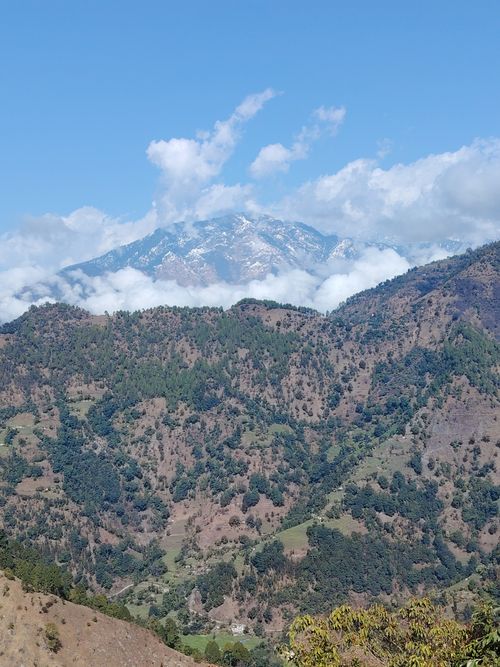 Free Breathtaking view of Api Himal with lush forests and clouds in Nepal. Stock Photo