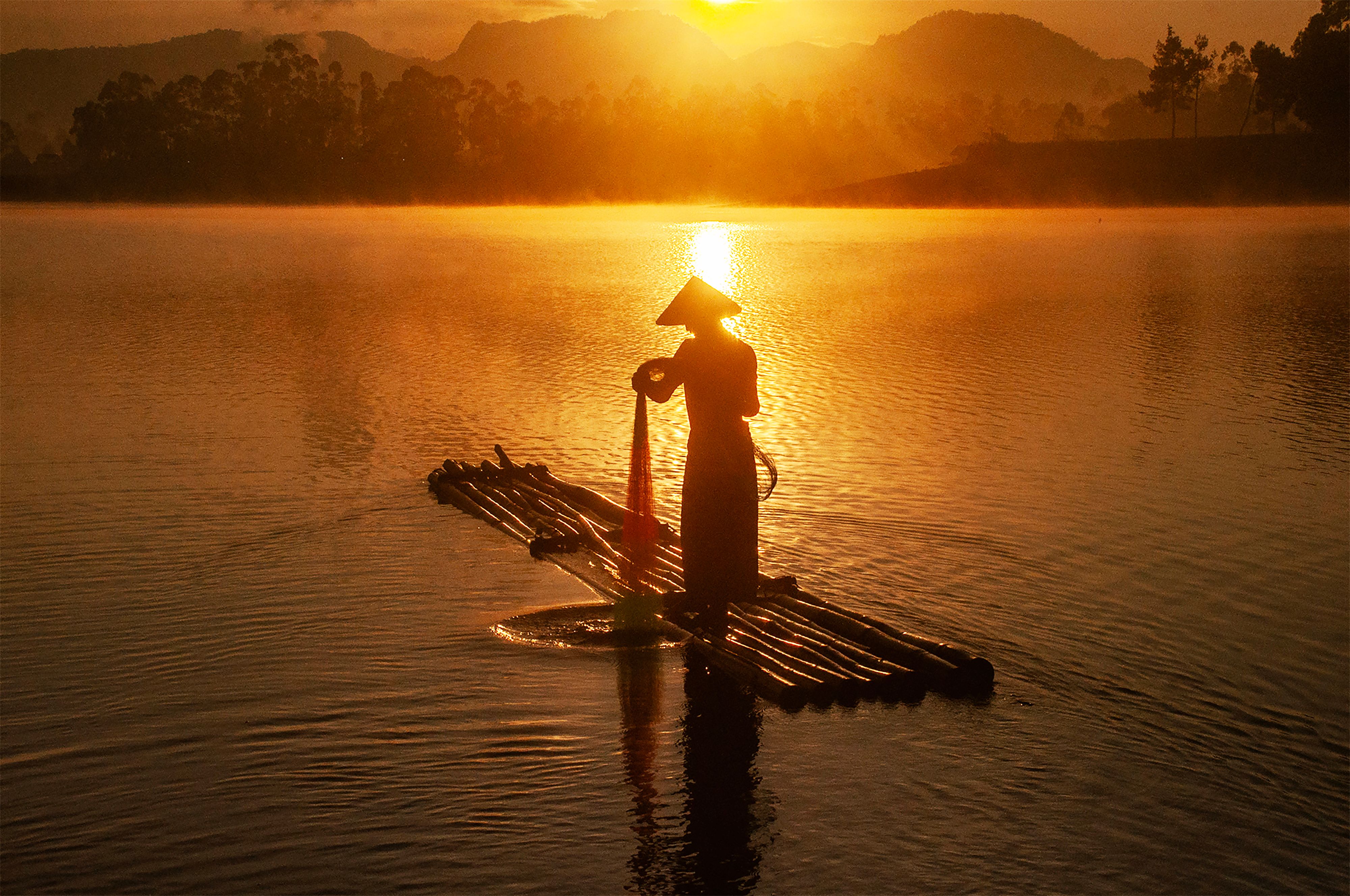 Traditional Fisherman on a Raft at Sunrise in West Java · Free Stock Photo