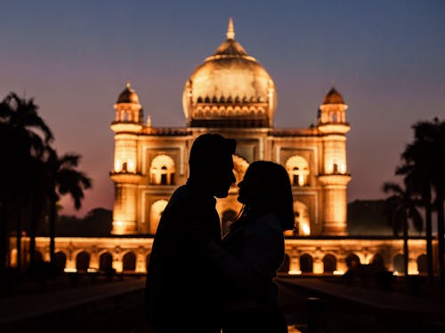 Silhouette of Man Kissing a Woman Near Dome Building