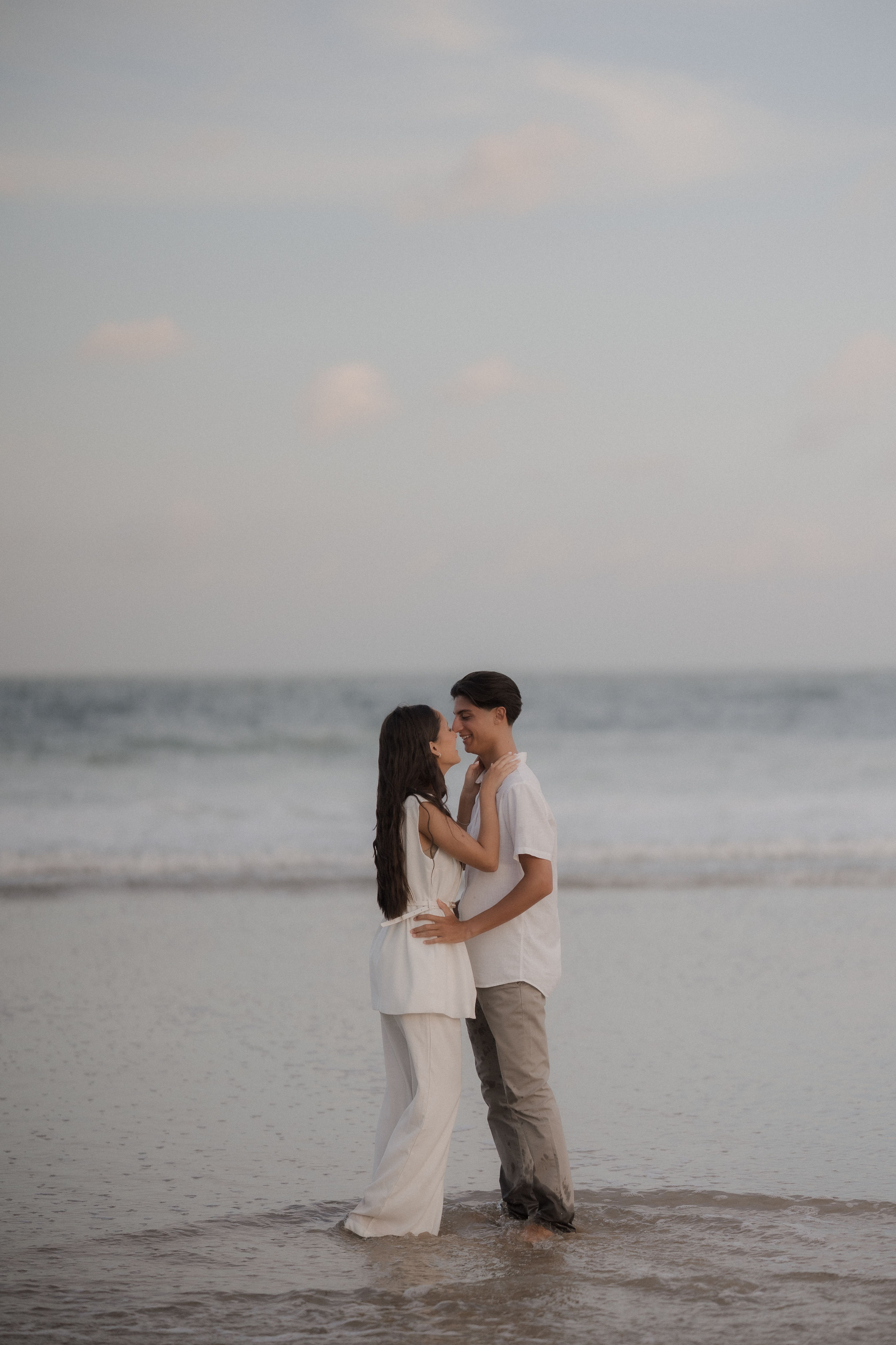 Romantic Couple Embracing on a Beach at Sunset · Free Stock Photo