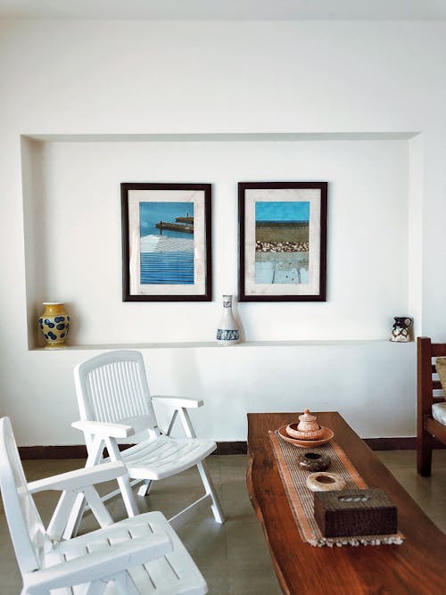 Interior of dining room with chairs and pictures in frames