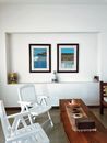 Interior of dining room with chairs and pictures in frames