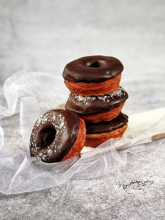 Free Close-Up Photo Of Stacked Chocolate Doughnuts Stock Photo