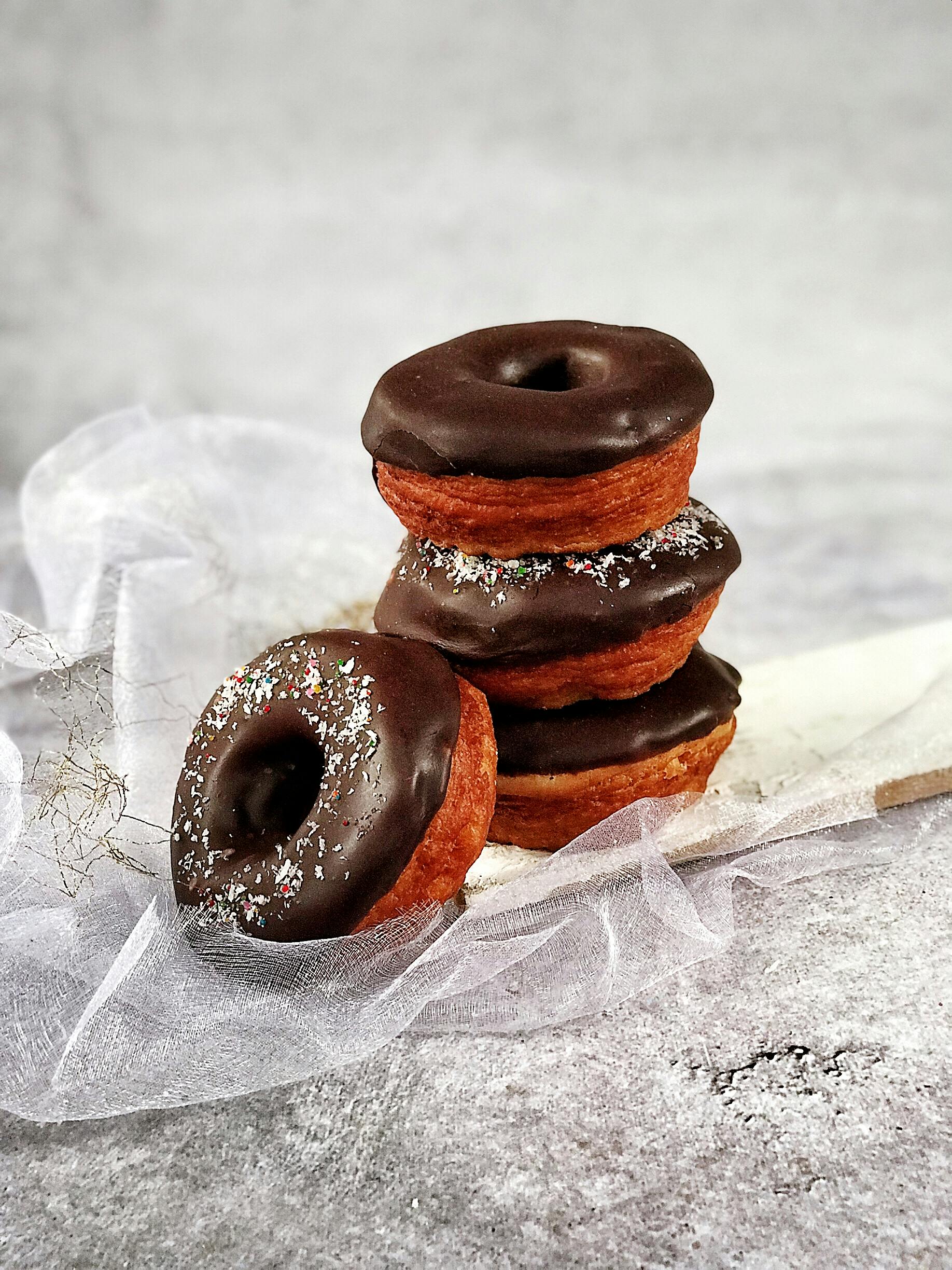 Close-Up Photo Of Stacked Chocolate Doughnuts · Free Stock Photo