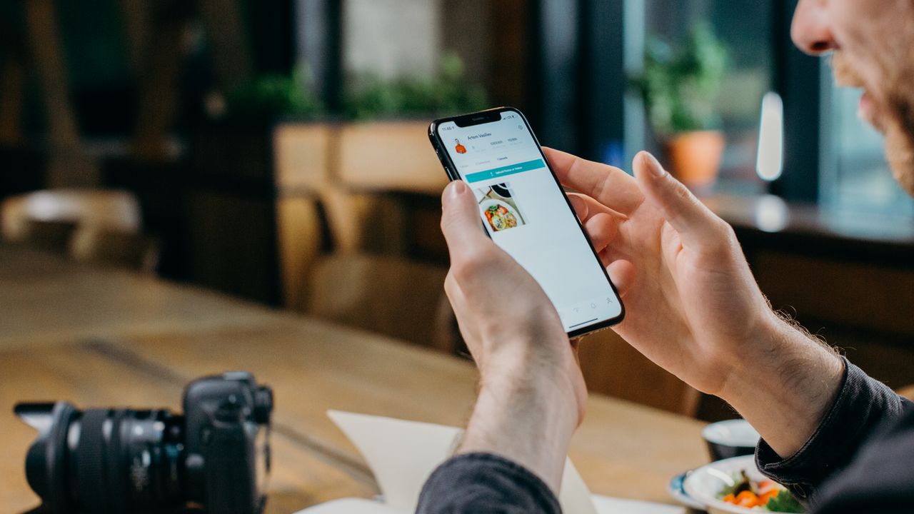 Reducing smartphone notifications Person using a smartphone while reviewing digital habits and notifications