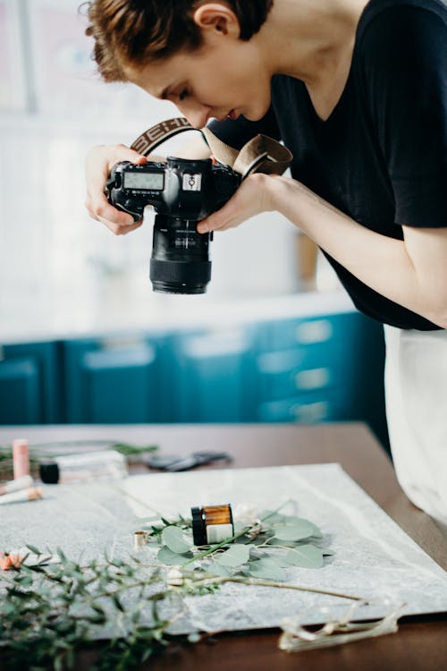 Woman Holding Camera Taking Photo Of A Jar