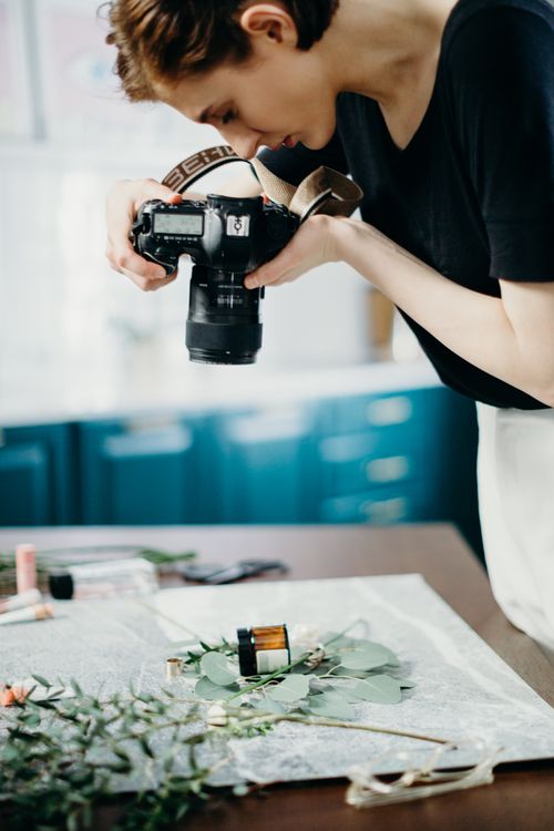 Person Using Camera Photo on Brown Surface · Free Stock Photo