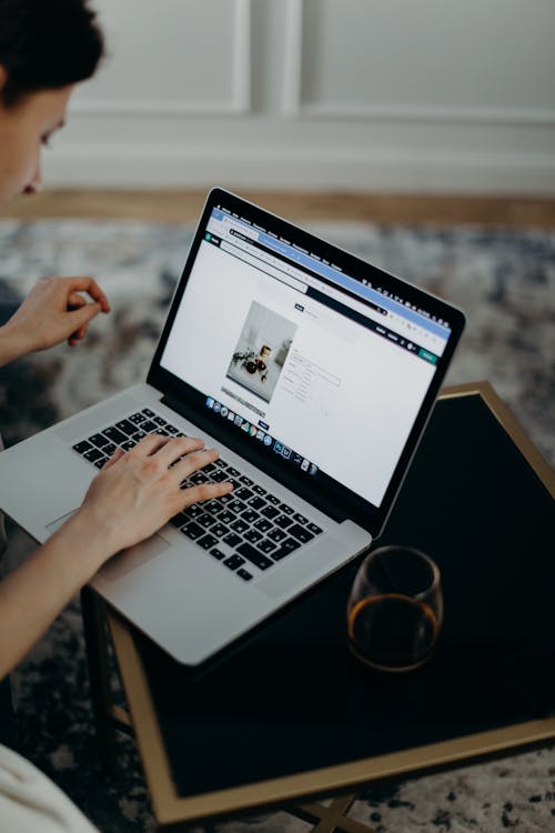 Selective Focus Photography Of Person Using Macbook Pro