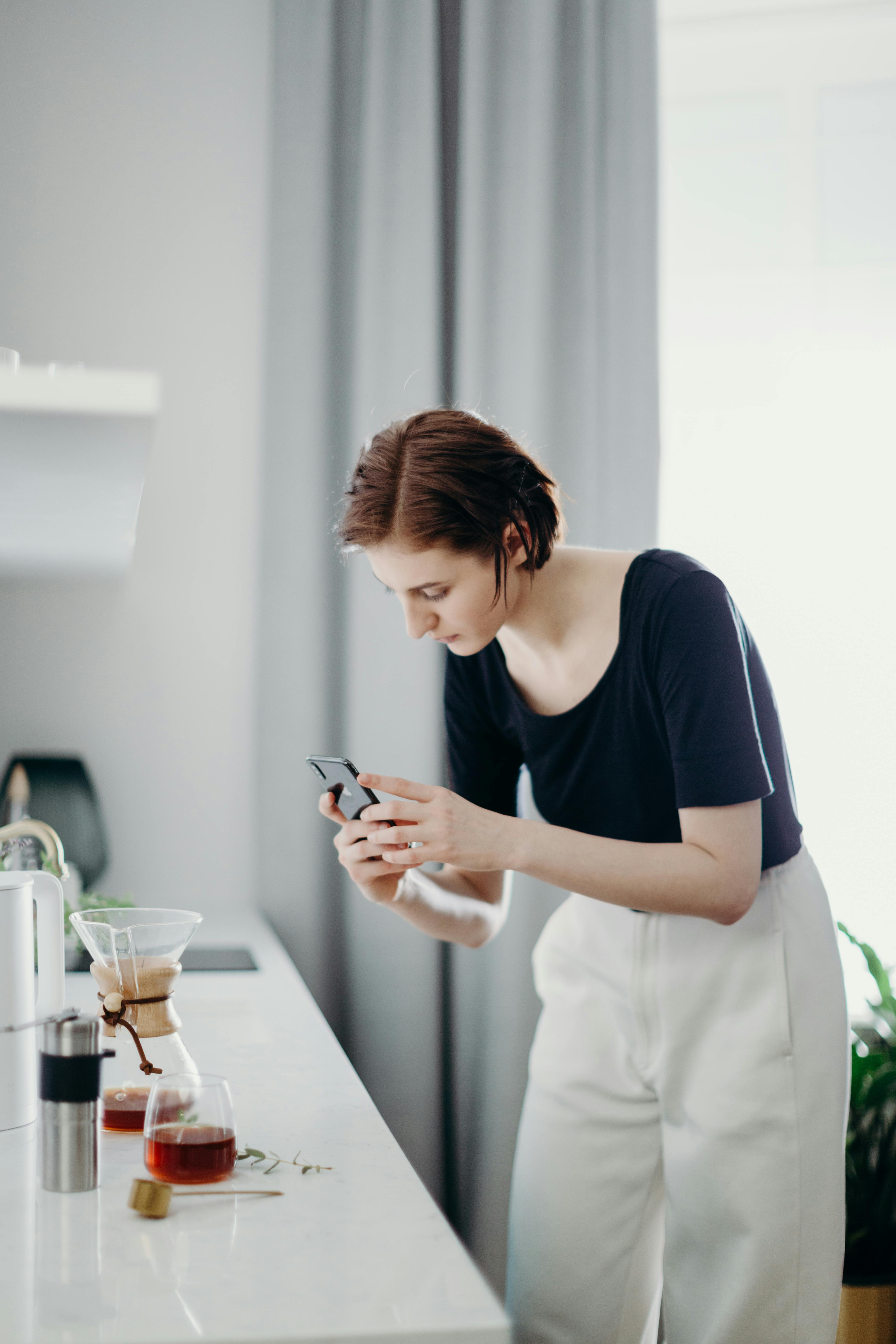 woman taking photo of coffee pot