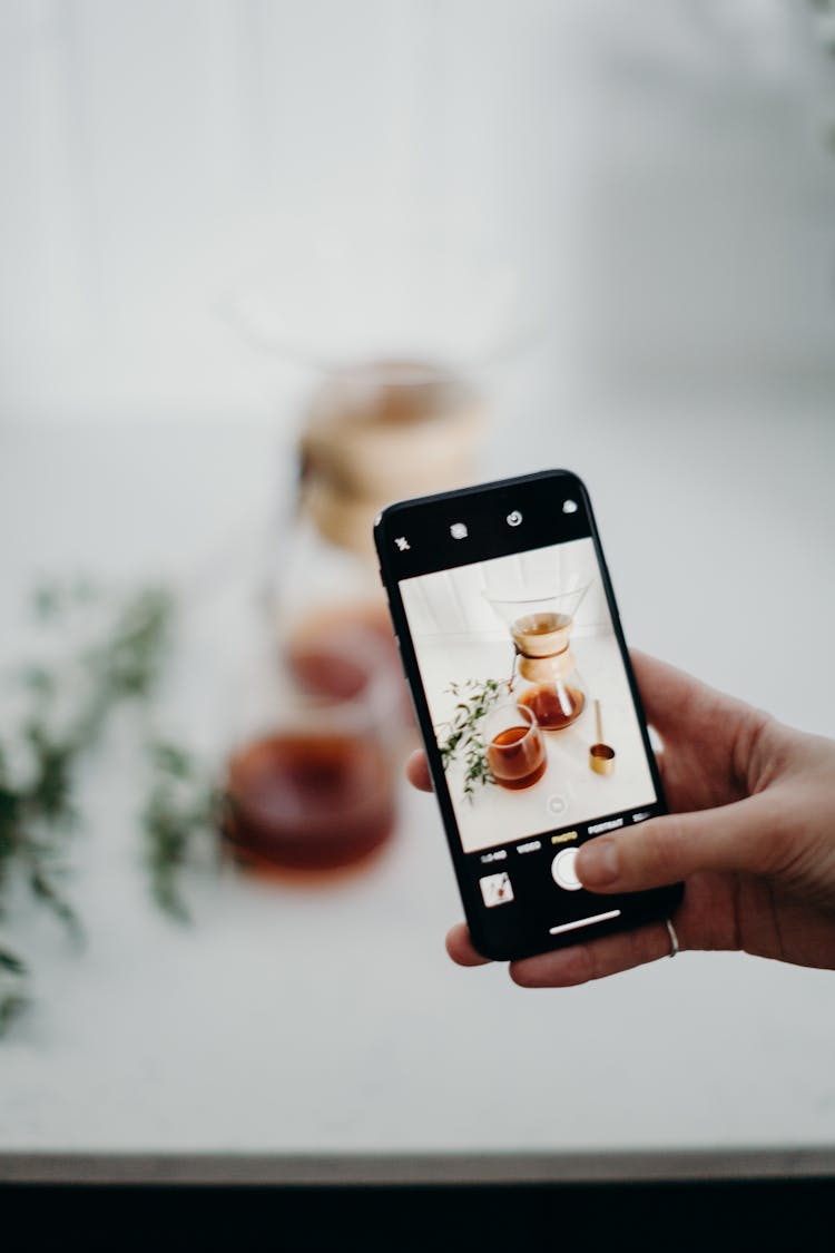 Person Taking Photo Of Coffee Pot Using Smartphone