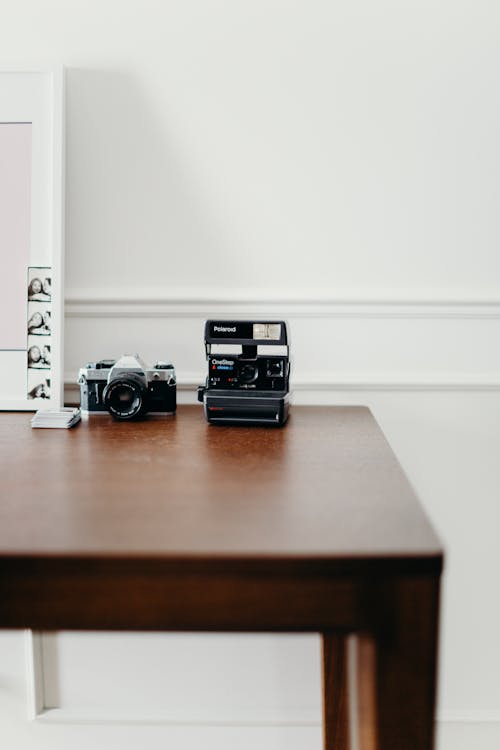 Photo of Polaroid Camera on Wooden Table