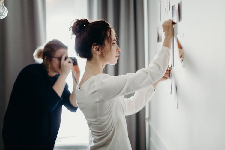 Woman Putting Photo On The Wall