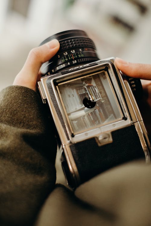 Person Holding Black Film Camera