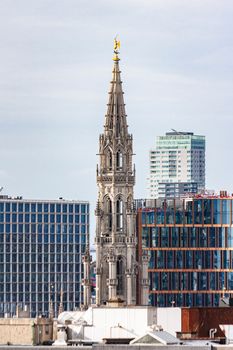 View of Brussels skyline with the historic Town Hall tower amidst modern buildings.