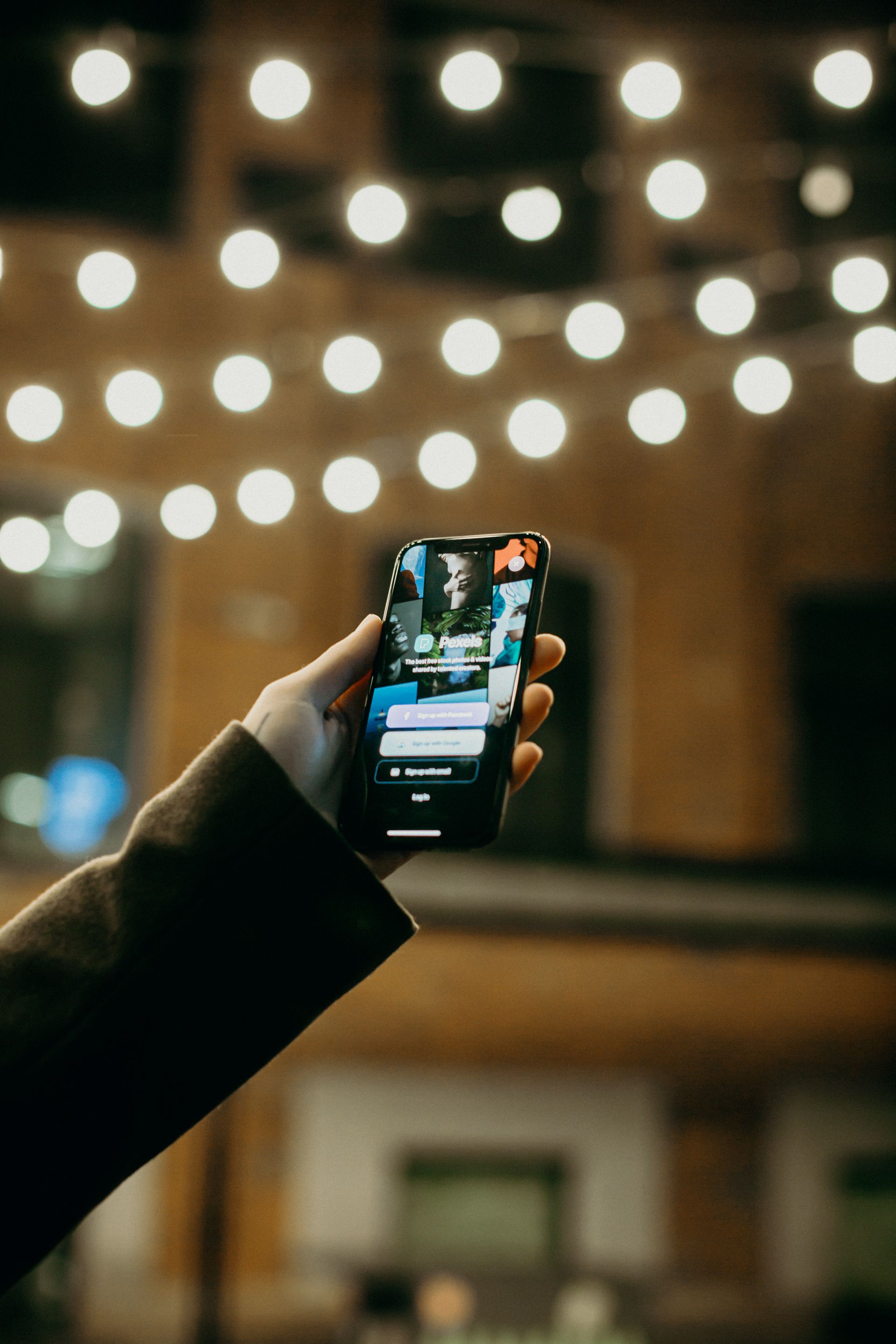 Hand holding a smartphone running a mobile app