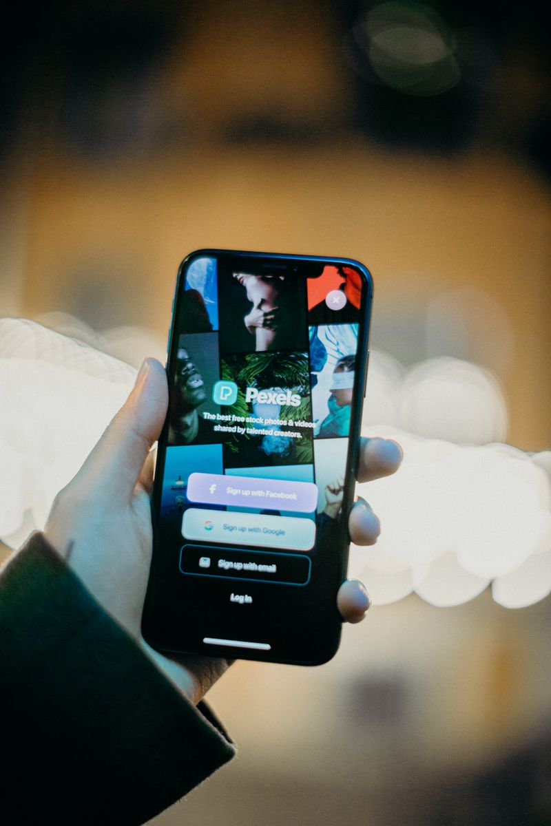 A hand holding a smartphone displaying a premium subscription paywall screen with pricing tiers and a bold call-to-action button