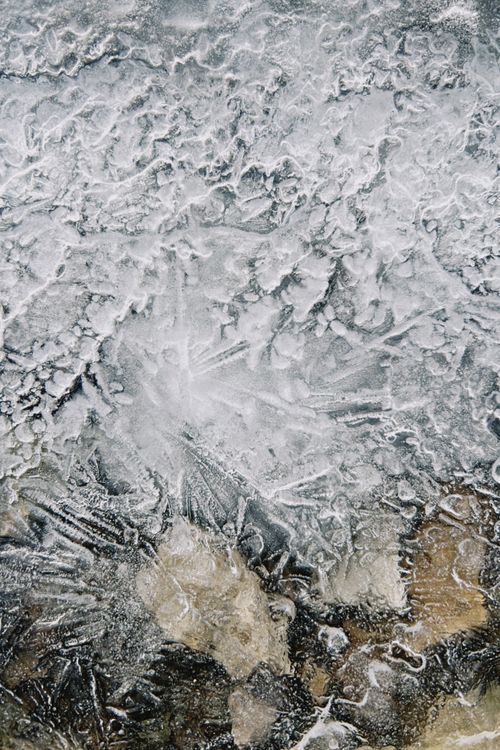Free Close-up of intricate ice patterns formed on rocks, capturing nature's artistry in winter. Stock Photo
