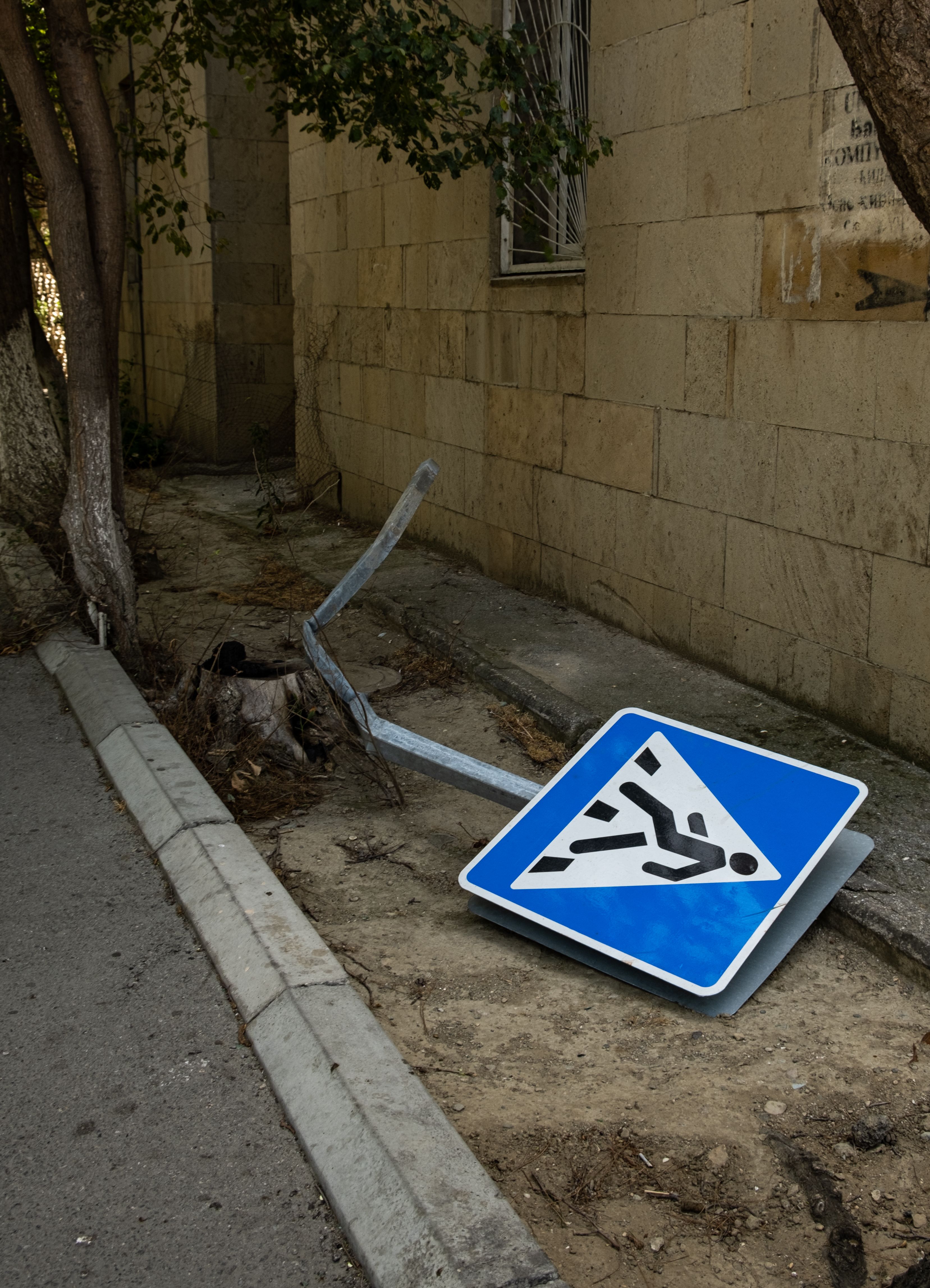 Fallen Pedestrian Crossing Sign on Urban Street · Free Stock Photo